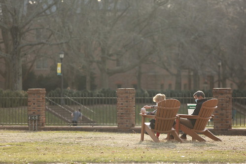 Campus visitors grab the perfect seats to watch all the activities taking place in the Sunken Garden on the first Spring Break Day of the year.