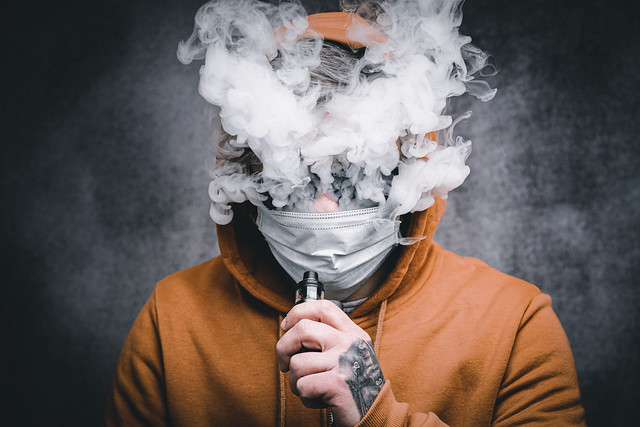 Man Vaping on Electronic Cigarette Large Clouds
