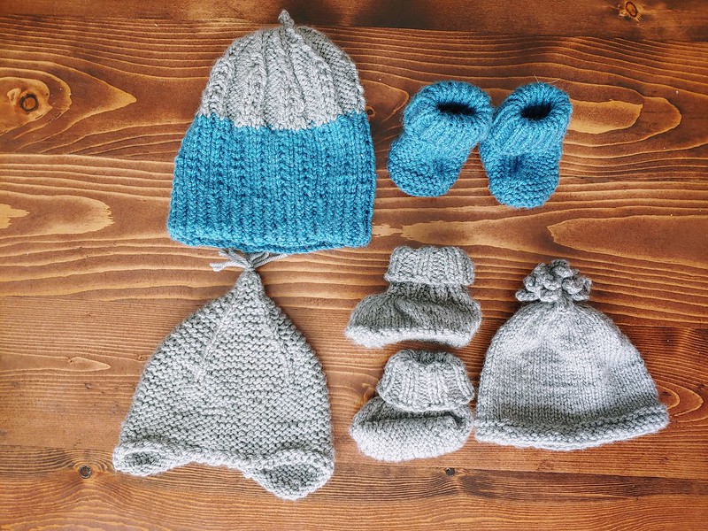 Homemade knitted baby hats with matching booties