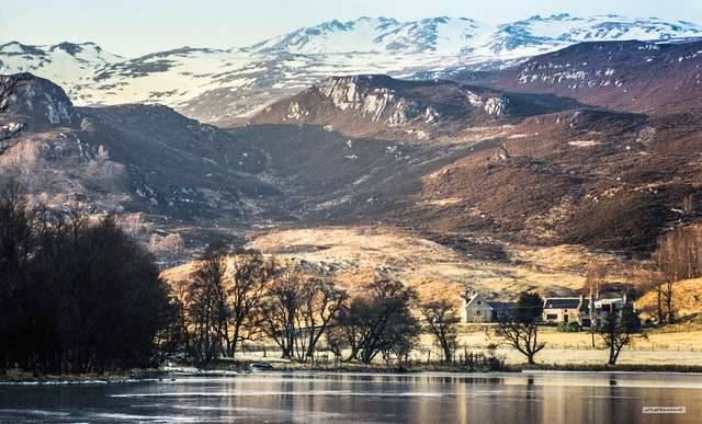 A frozen Loch Craskie and Craskie Farm below the hills of Glen Cannich at sunset in November. As the glen turns west it's grandeur and scale increase.