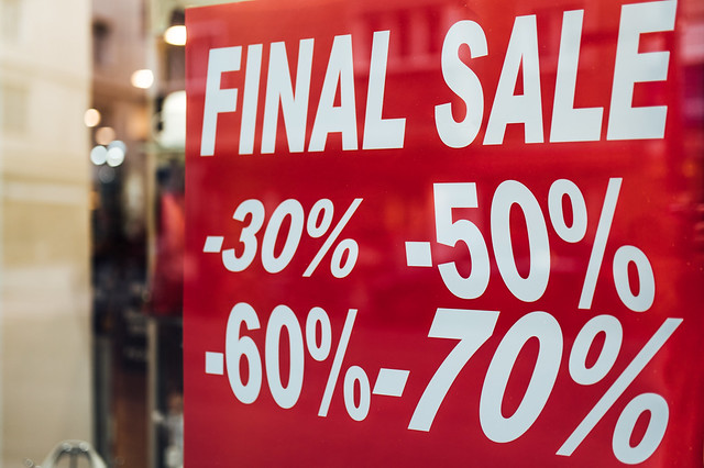 Close-up of a discount sign in a store advertising discounts from 30% to 70%. Winter clearance sale