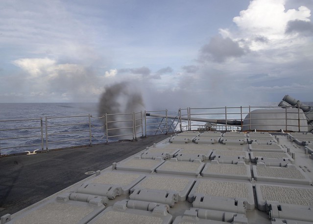 USS Bunker Hill fires its Mark 45 5-inch gun during a live-fire exercise in the Indian Ocean