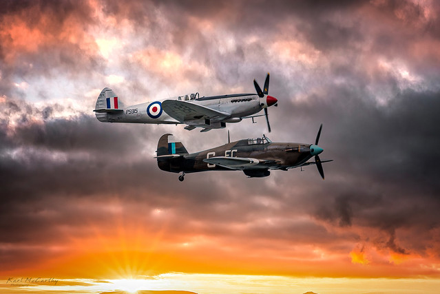 Spitfire and Hurricane flying accross a beautiful sky