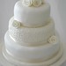 Ivory filigree piping cake wtih pearls and roses