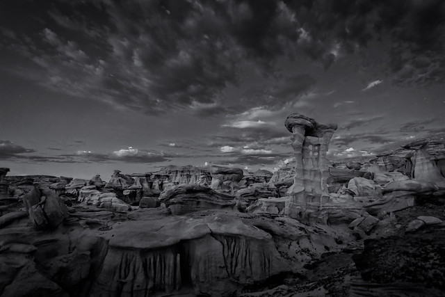 Stars and clouds over the “Alien Throne” and other hoodoo sandstone rock formations in the Valley of Dreams in the Ah-Shi-Sle-Pah Wilderness Study Area, New Mexico