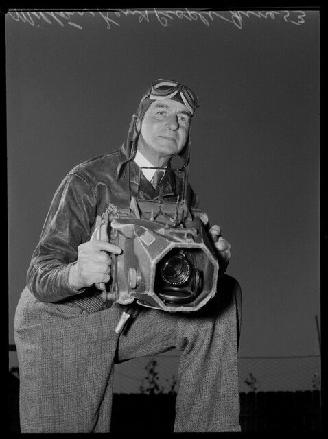 Photographer Milton Kent holding his aerial camera, Sydney, June 1953