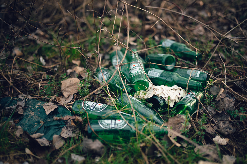 A pile of glass beer bottles left on the ground