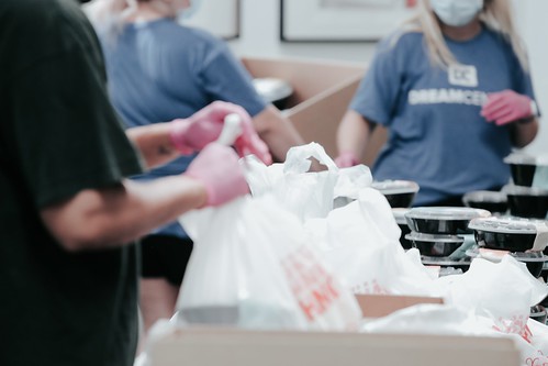 Image of social service members packing supplies in plastic bags - Eight Government Jobs That Don't Require a Four-Year Degree