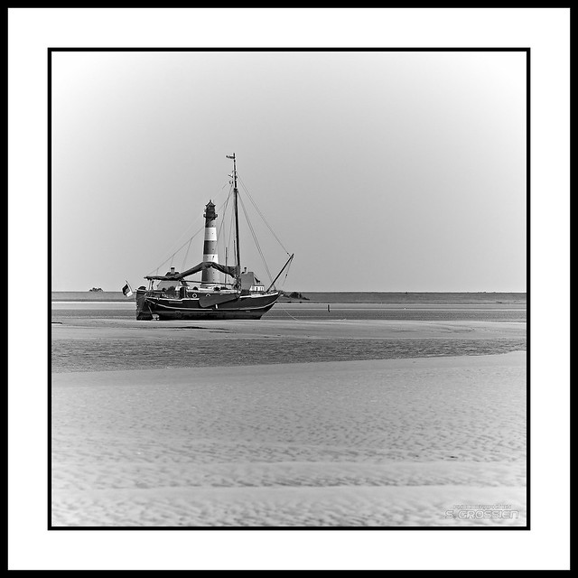 Sailboat 'Schwattes Schop' in front of Lighthouse Westerhever Sand