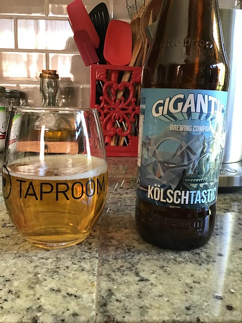 Gigantic Kolschtastic bottle, and glass of kolsch ale on counter. 