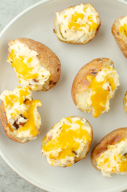 Overhead shot of small twice baked red potatoes topped with melted cheese