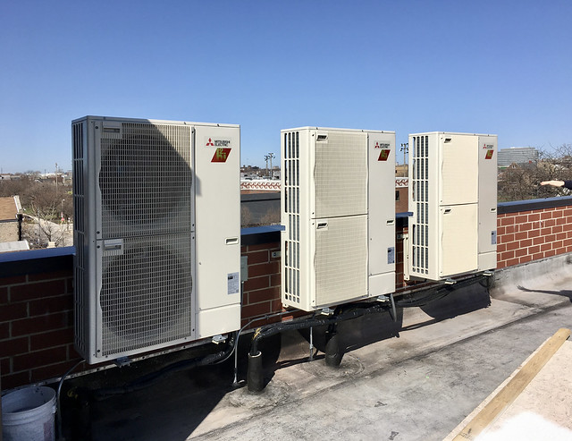 Three outdoor heat pumps on the roof
