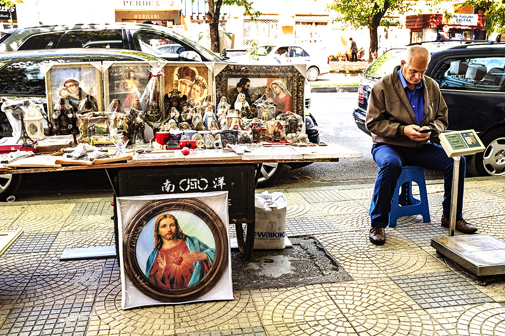 Stall selling Christian icons and man with scale on 5-3-21--Shkoder