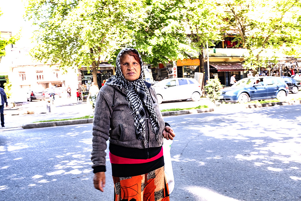 Woman crossing Qemal Dracini Street on 5-3-21--Shkoder