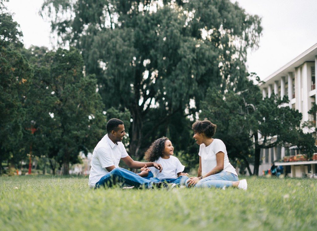 A family sitting in a park