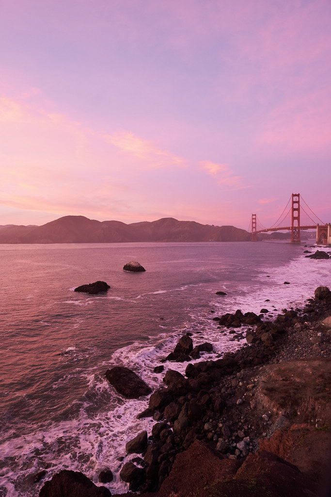 The golden-gate bridge at sunset with a golden-red sky