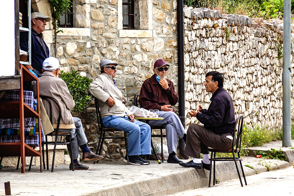 Five men talking in old city on 5-12-21--Berat