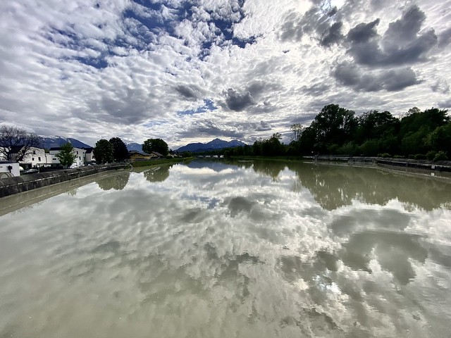 Cloudy sky and its reflection in the water of the Saalach river