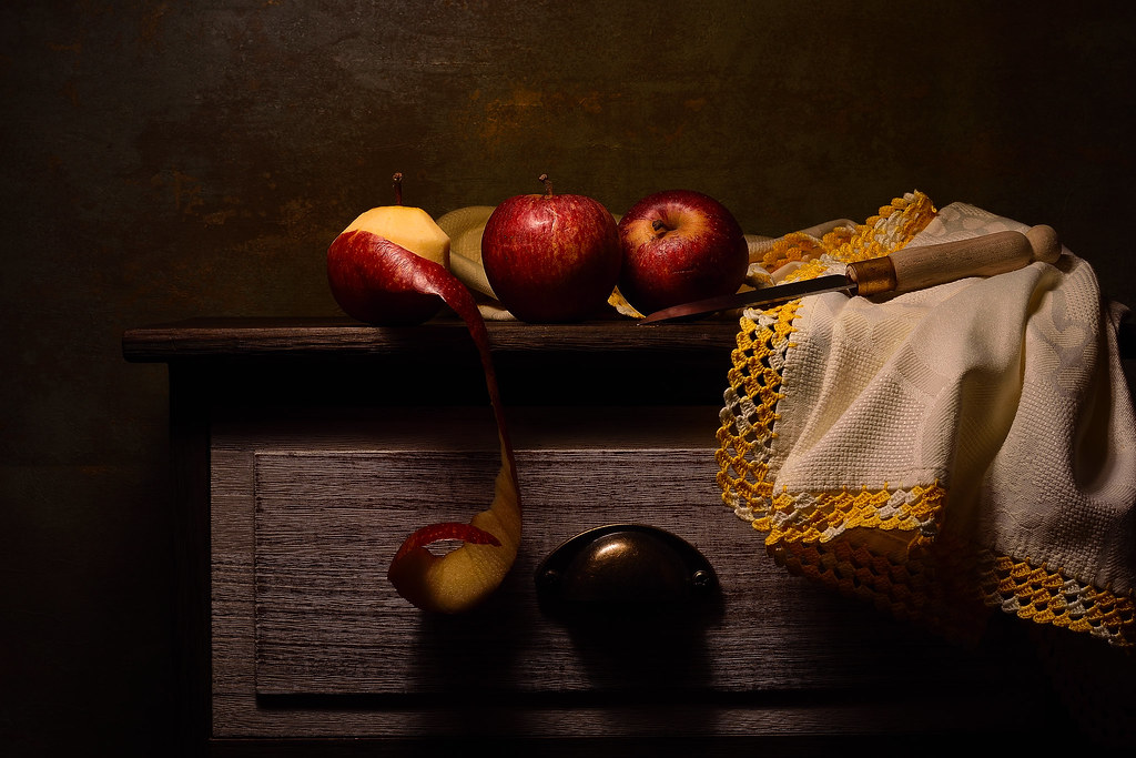 Still life with three red apples
