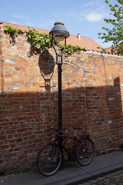 Medieval walls, old gas lantern and bicycle
