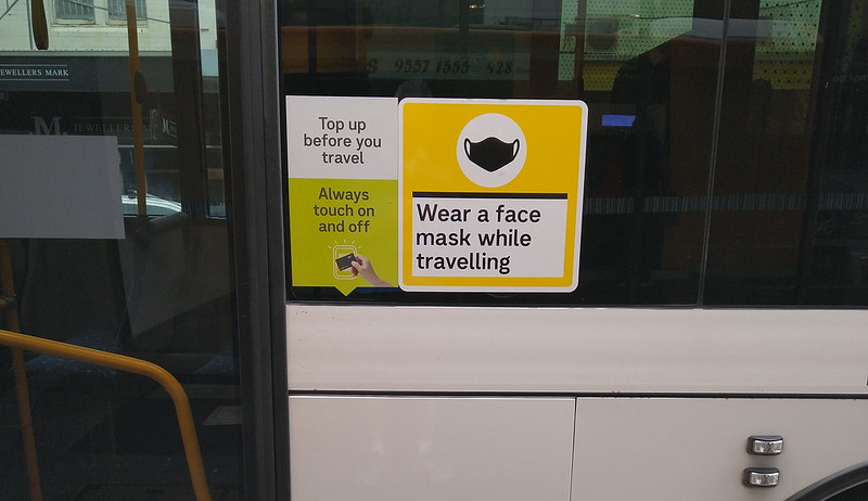 Face mask signage on a bus