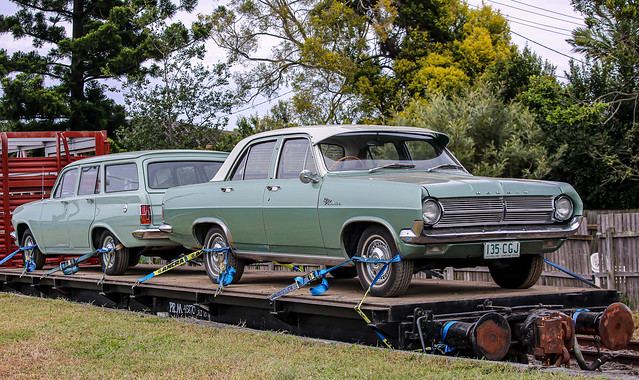 Holden station wagon and Holden Premier sedan on QPSR train carriage at Swanbank.