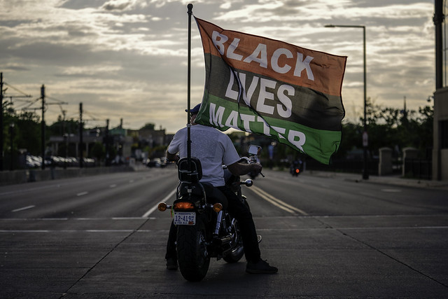 A motorcyclist carries a Black Lives Mater banner during a march and rally at the Minnesota State Capitol on Monday in St Paul