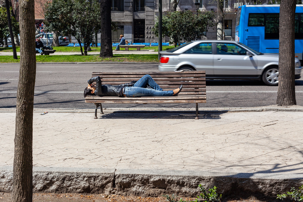 Woman Lying on a Bench