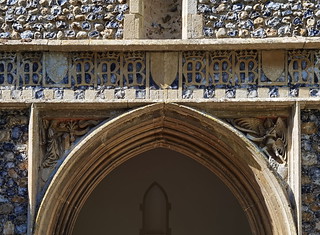 south porch: Blessed Virgin and Gabriel at the Annunciation under a row of Ave Maria Regina monograms