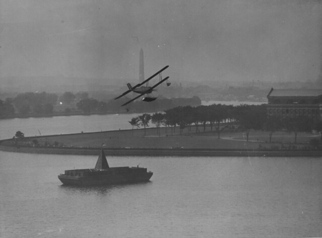 A Seaplane rounding the Pylon Barge in the Anacostia River, off the Army War College. Washington Monument in the background Washington, DC during the Curtiss Trophy Races, May 1929.