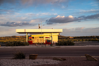 Gallup, New Mexico - May 17, 2021: Abandoned gas station sits empty along Route 66 at sunset and golden hour
