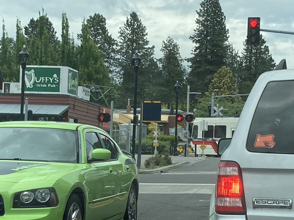 The snoot of a northbound train peeks through the traffic @ Washington St in Milwaukie Oregon