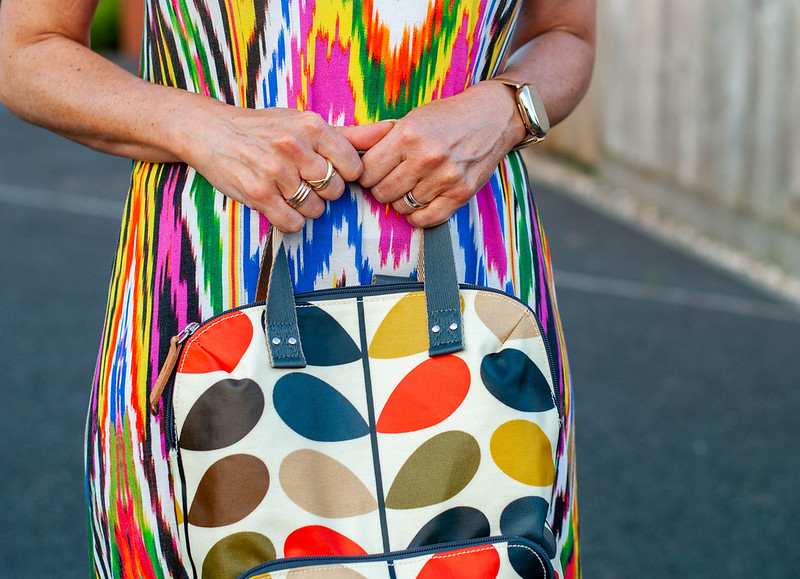 Layering a Rainbow-Explosion Maxi for Summer: Catherine Summers AKA Not Dressed As Lamb wearing an ikat-print multi-coloured maxi with white vest top, Panama hat, navy chunky sandals and an Orla Kiely backpack | Style over 40