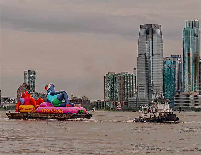 Tugboat Pulling Cartoon TV Program Advertising in New York Harbor