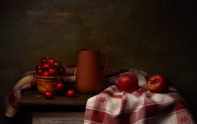 Still life with cherries and red apples