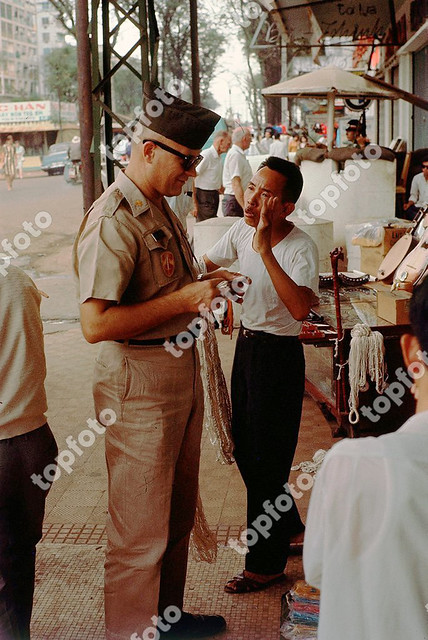 An American soldier bartering with a Vietnamese travelling salesman, 1969, Vietnam