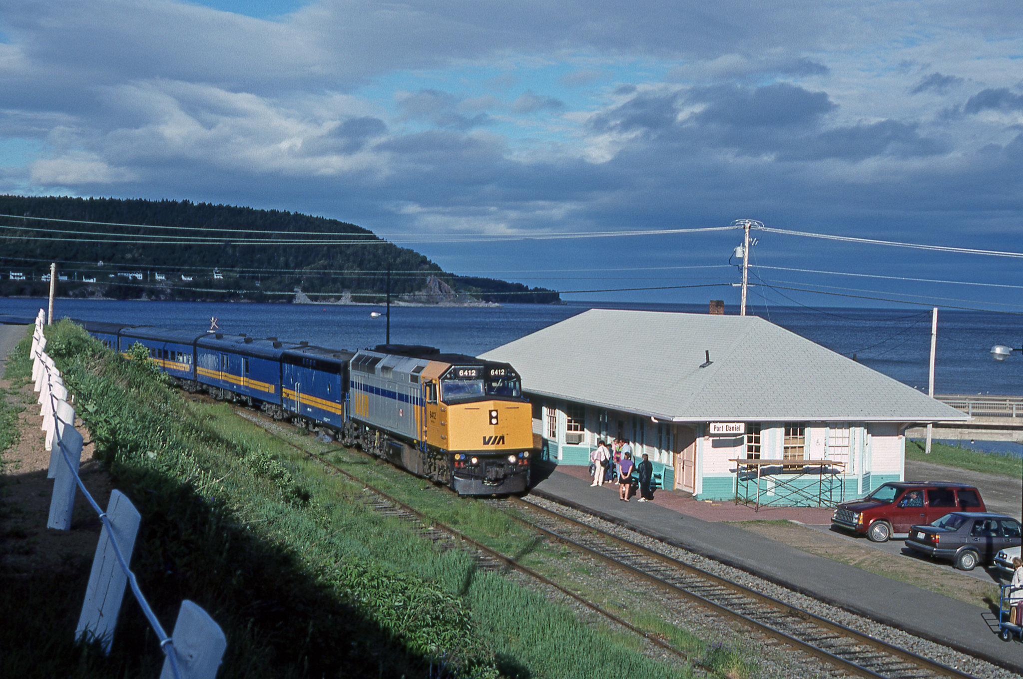 VIA # 17, the westbound Chaleur, slows for its station stop at Port-Daniel. The long days of early summer often played well when chasing and photographing trains along the Gaspé Peninsula.

Port-Daniel, Quebec.
Monday, July 1, 1991