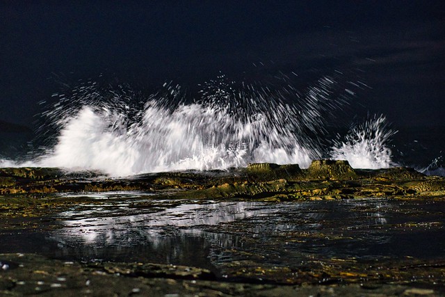 Waves washing against the reef at night