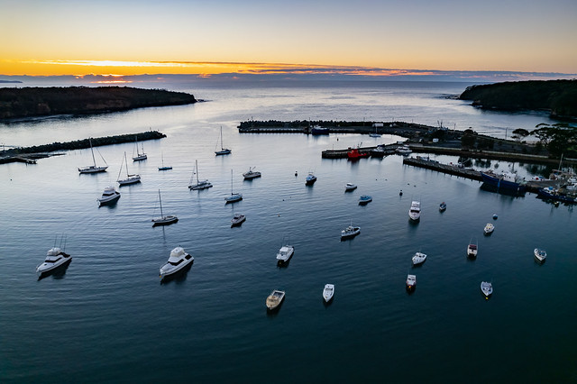 Sunrise over the harbour with low cloud bank and boats