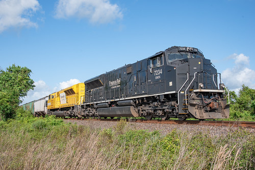 Ripe & Rotten by Christopher Parma, A pair of EMDX leaser SD70's wait on the rear of a KCS grain train holding at Crosby northeast of Ho