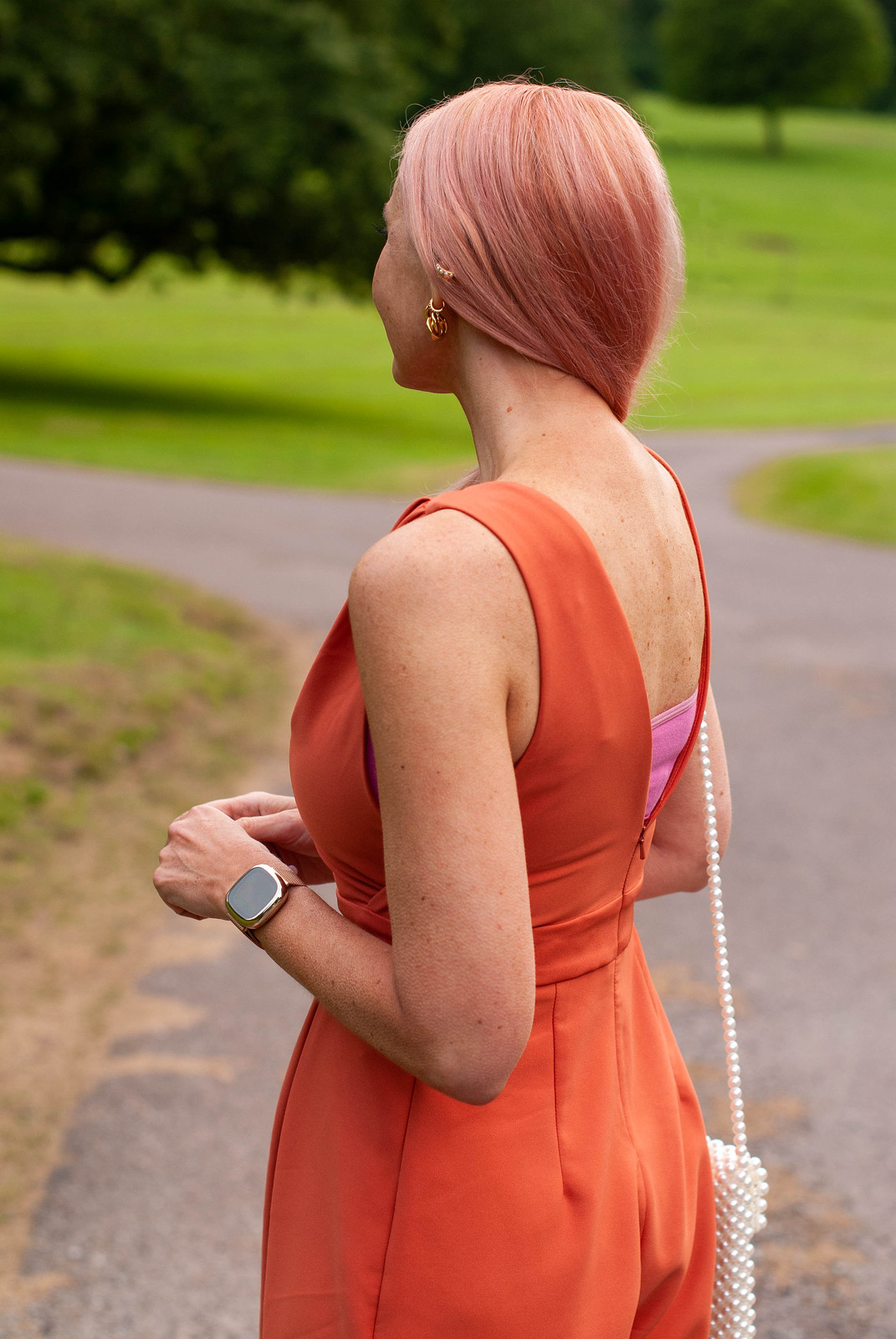 What to Wear to a Wedding Evening Reception: Orange v-neck jumpsuit, orange strappy heels, pearl phone holder | Catherine Summers, AKA Not Dressed As Lamb, Over 40 Fashion & Style