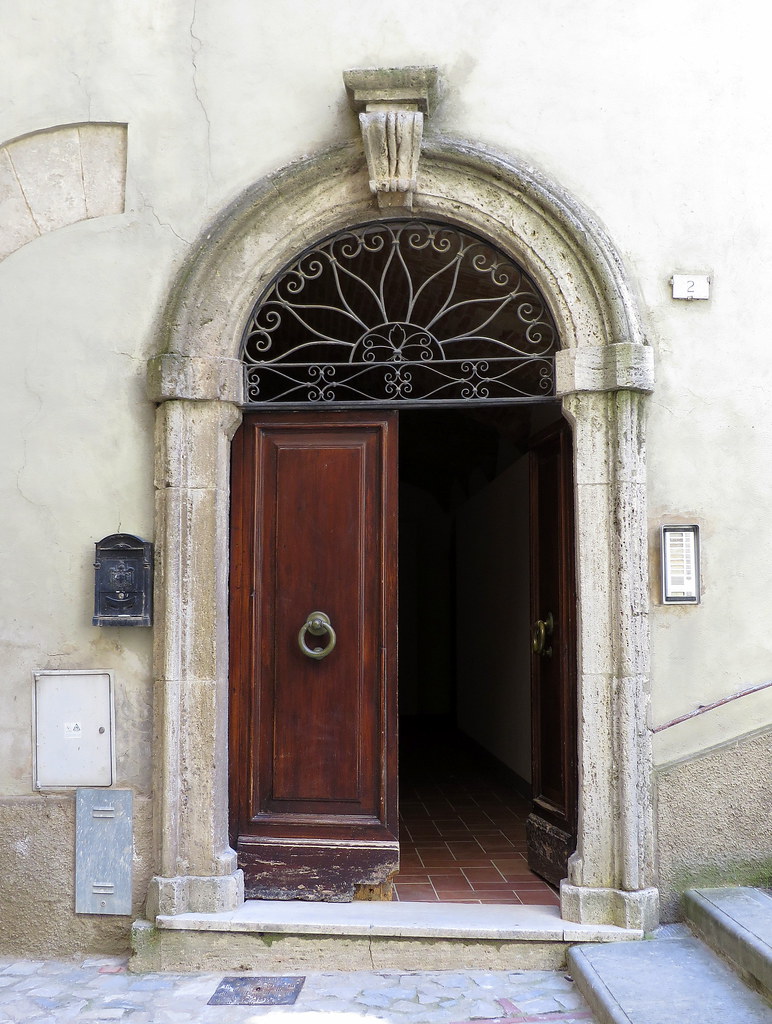 Doorway with ironwork transom window, Todi, Umbria, Italy