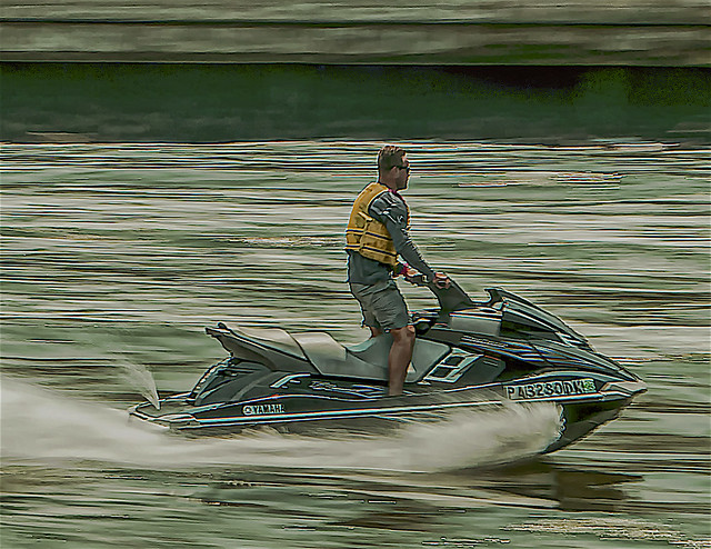 Candid of Man Ski Jetting on East River During Summertime Season