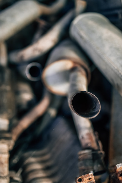 An exhaust pipe in a pile of scrap metal