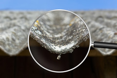 Dangerous asbestos roof. Asbestos dust in the environment. Health problems