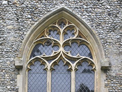 east window tracery with uncut headstops (19th Century) and wasps nest