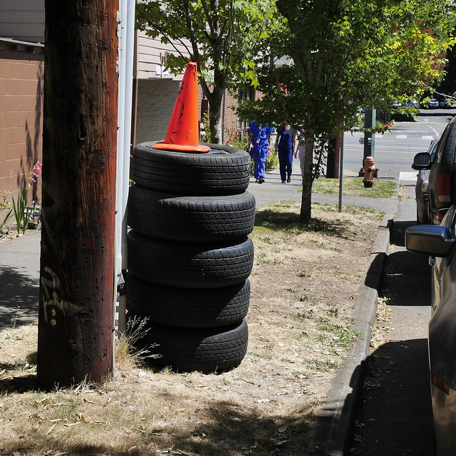 stack of tires, walkers in blue