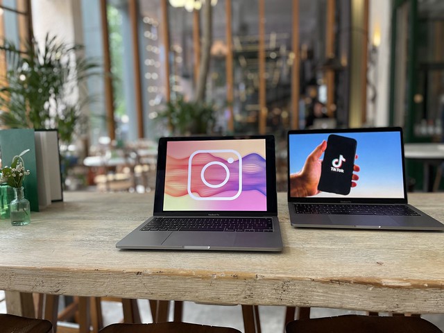 Instagram and TikTok logos displayed on a laptop