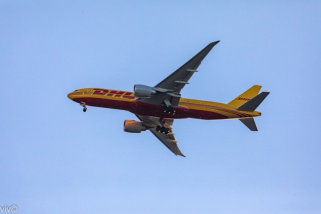 With Australia's dire need for Pfizer Covid vaccines, today's dusk DHL Boeing 777 approaches Sydney airport from Los Angeles over our garden - hopefully with supplies, Sydney, New South Wales, Australia