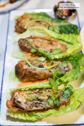 Spicy duck rolls - crispy rolls of roast duck, veggies, thai basil and chili. wrap with crunchy lettuce and eat like a taco